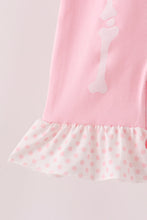 Pink skeleton print ruffle romper