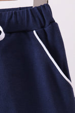 Navy scallop hem bow skort